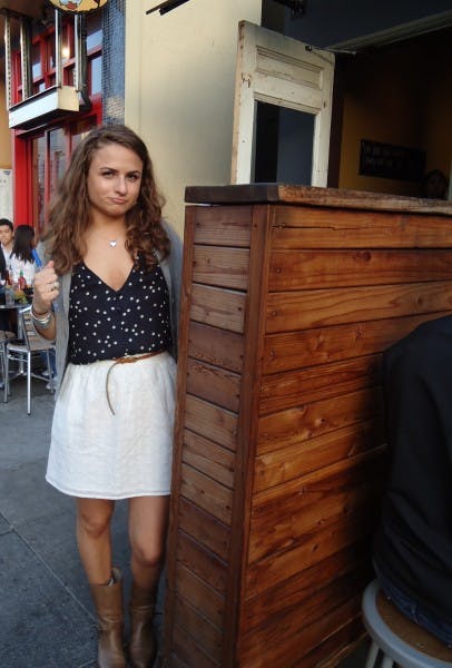 DSC00068 a woman posing near a wooden corner