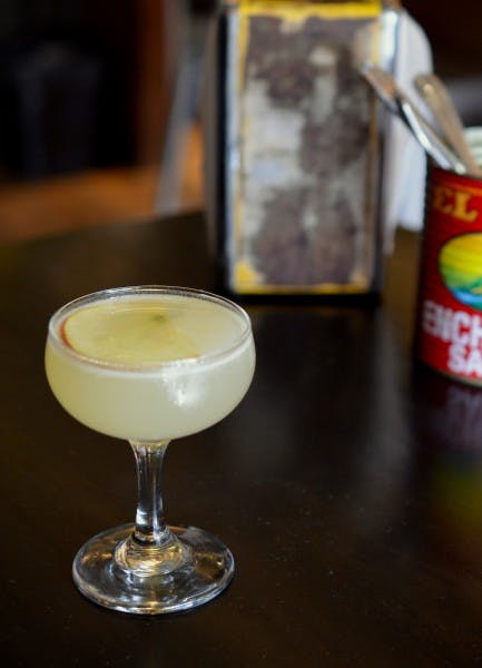 a juice served in a glass and looks like apple