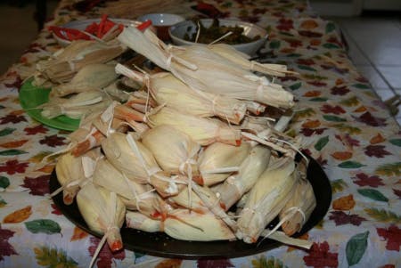 a pile of tamales placed over a table