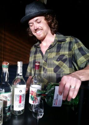 teddy our resident mezcal expert serving mezcal in a glass