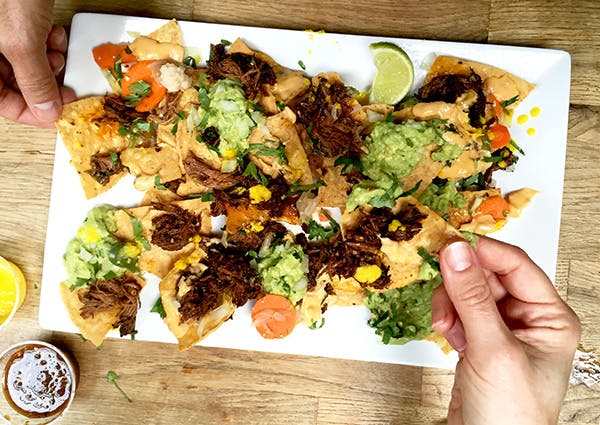 Nachos with guac, guajillo-beef short ribs, pickled jalapenos and lots of queso.