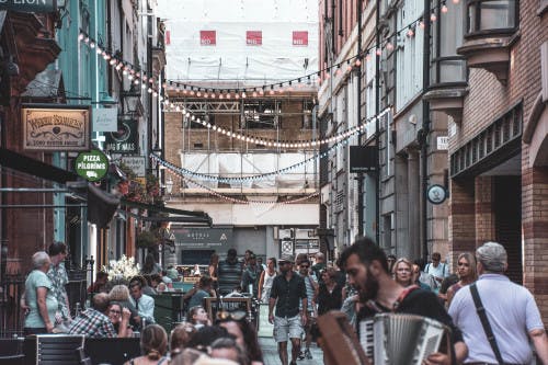 a group of people walking on a city street