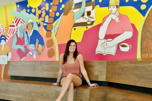 a woman sitting on a bench posing for the camera