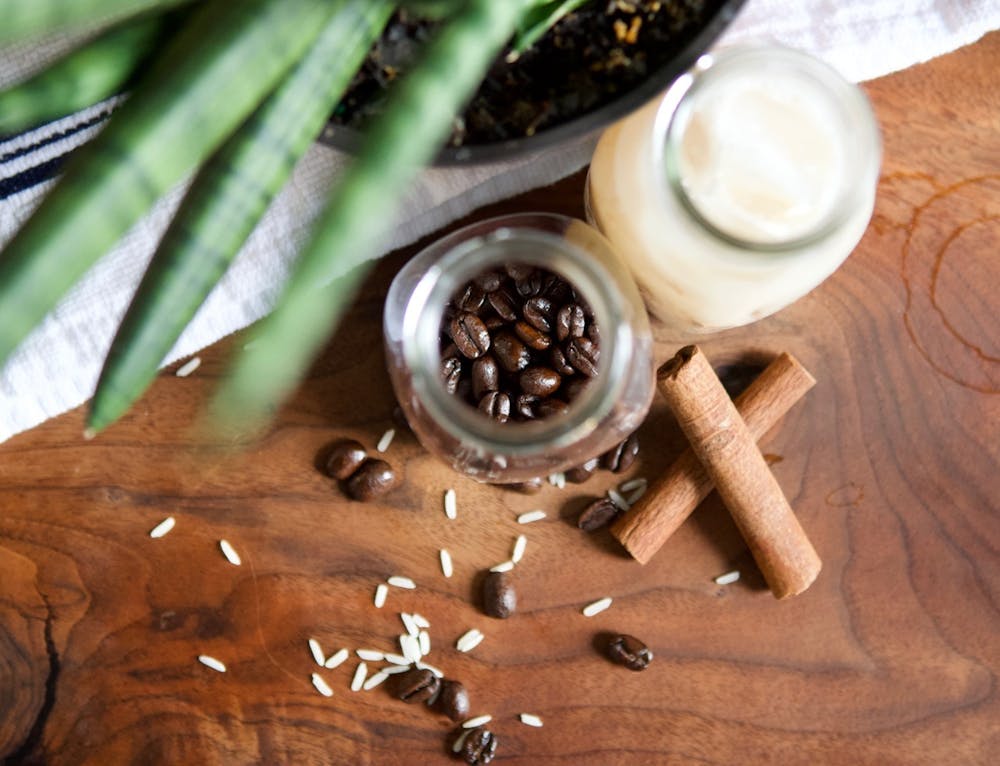 a cup of coffee sitting on top of a wooden table