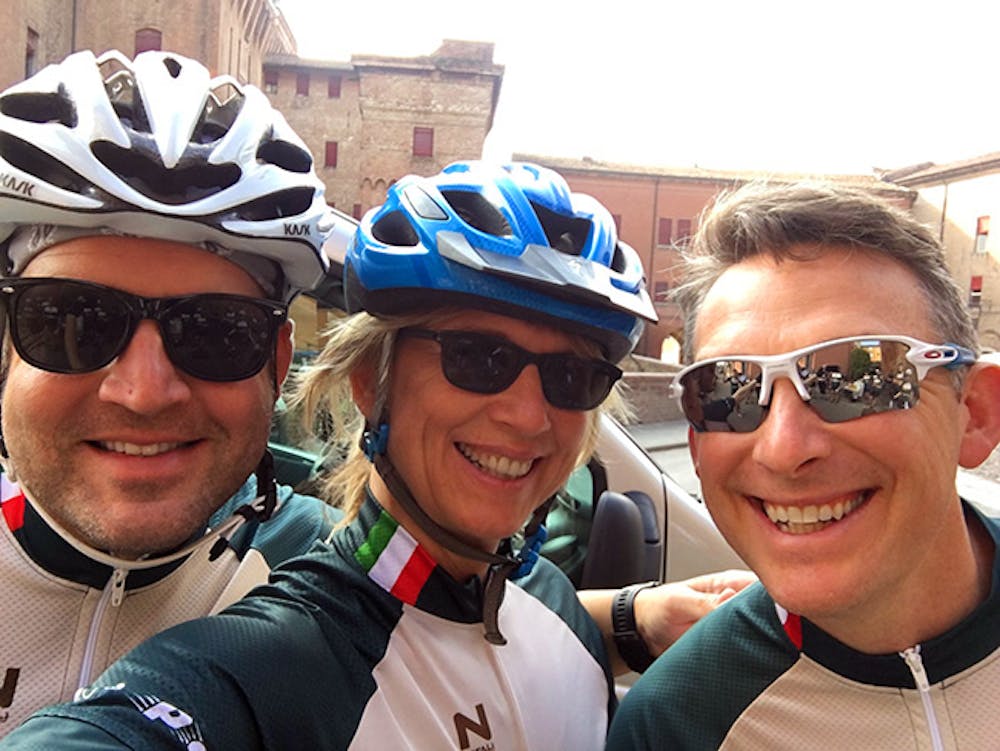 a group of people with bicycling equipment posing for the camera