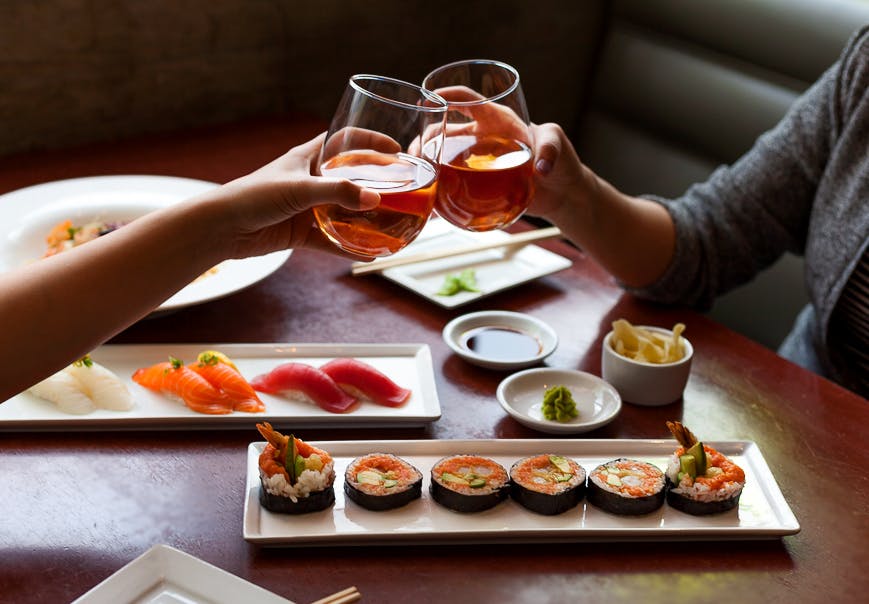 a person sitting at a table with a plate of food