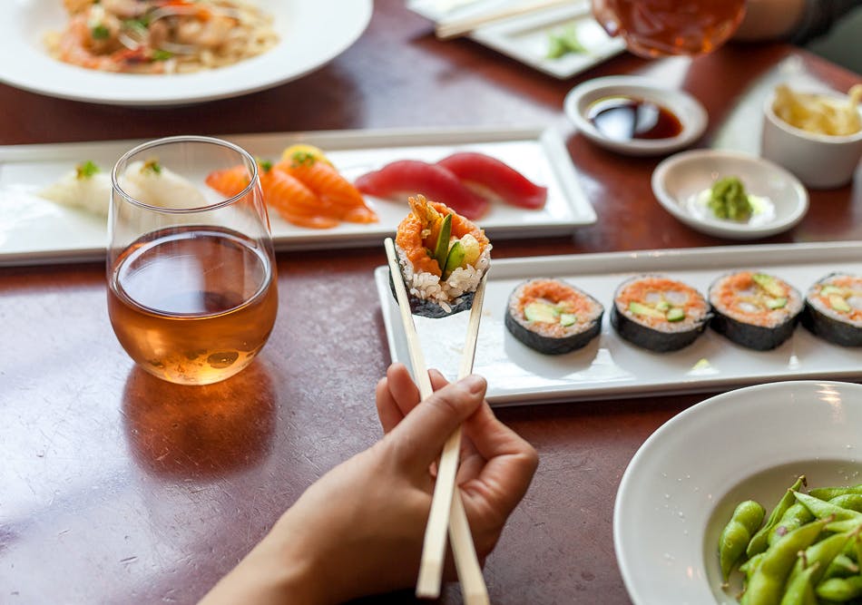 a group of people sitting at a table with a plate of food