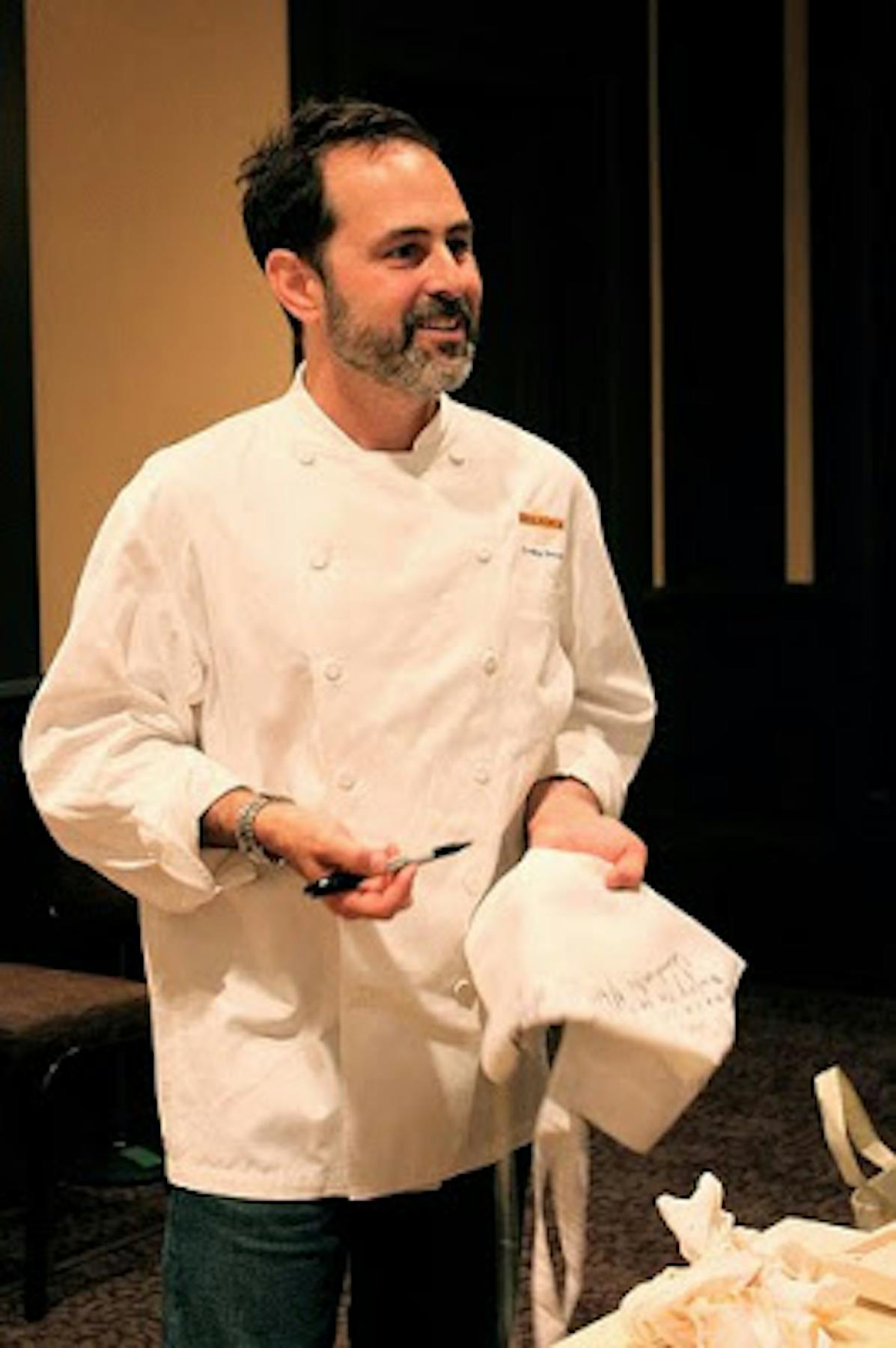 a chef holding a chef hat