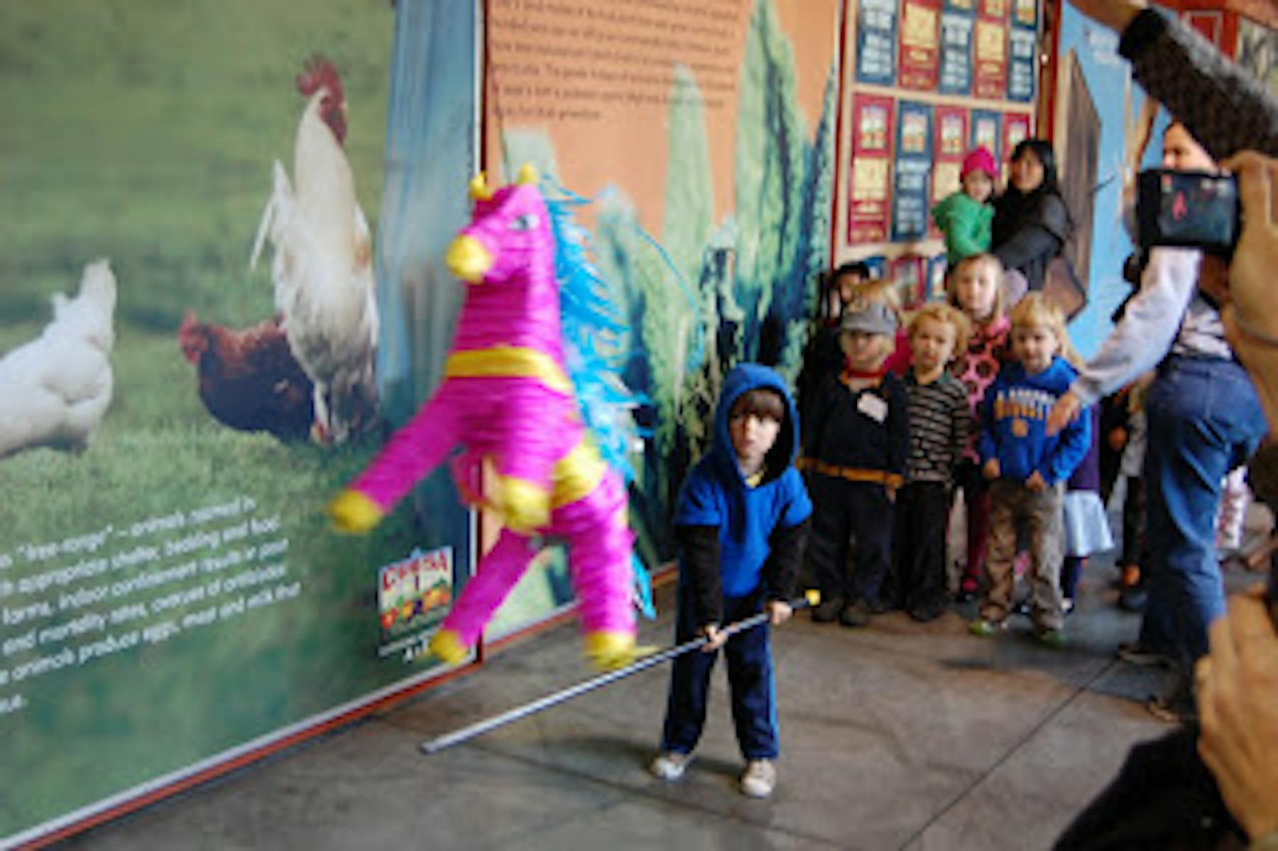 a kid playing with a piñata