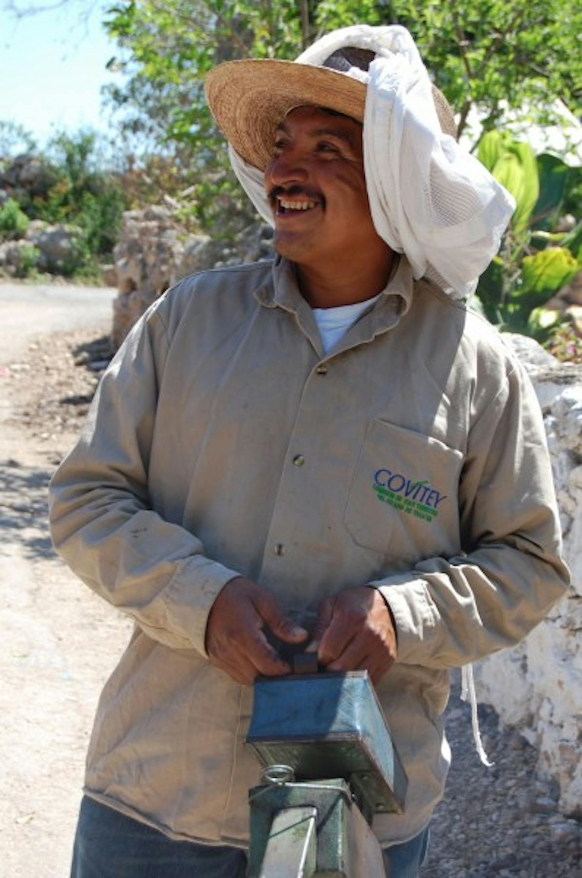 Juanito's brother back from working with honey bees.
