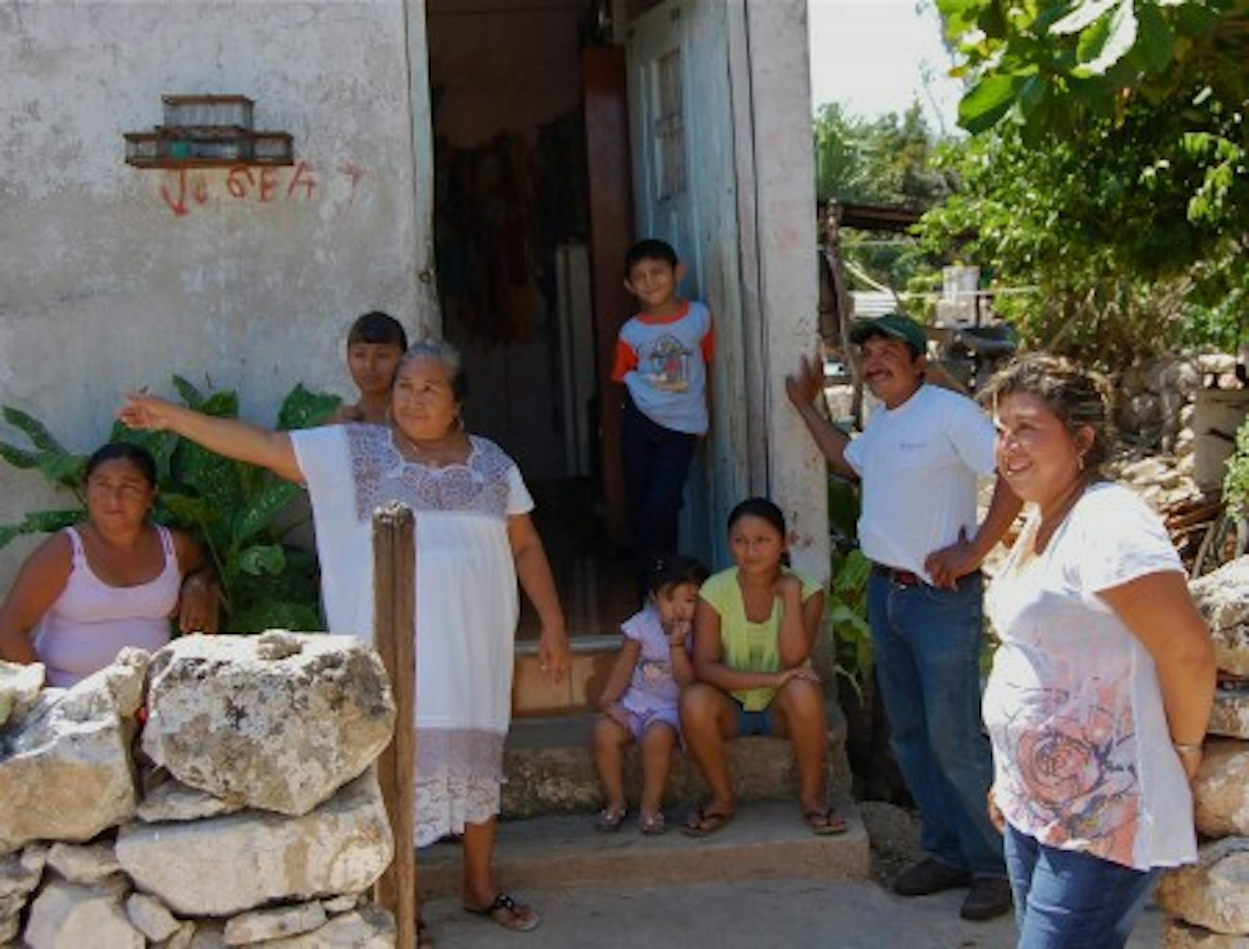 the family posing outside of the house