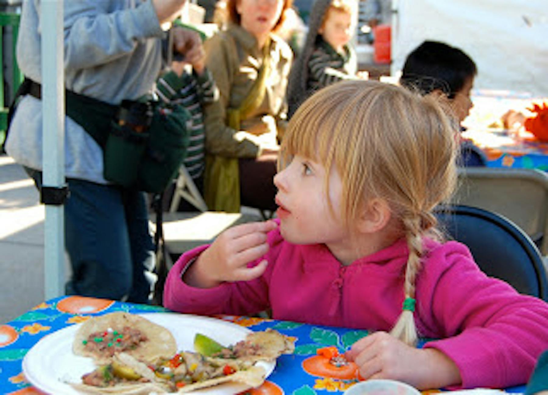a girl eating tacos