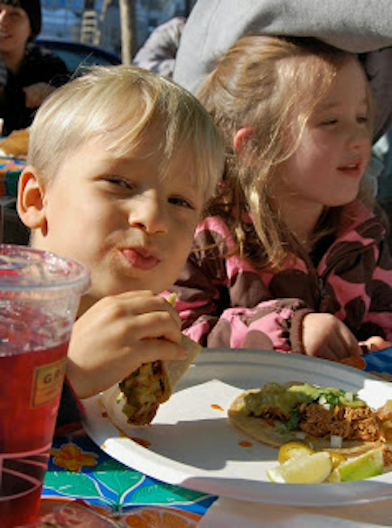 a boy eating tacos