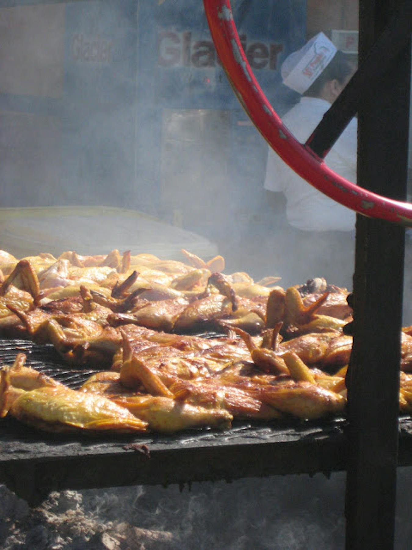 chicken on the grill outside of the market