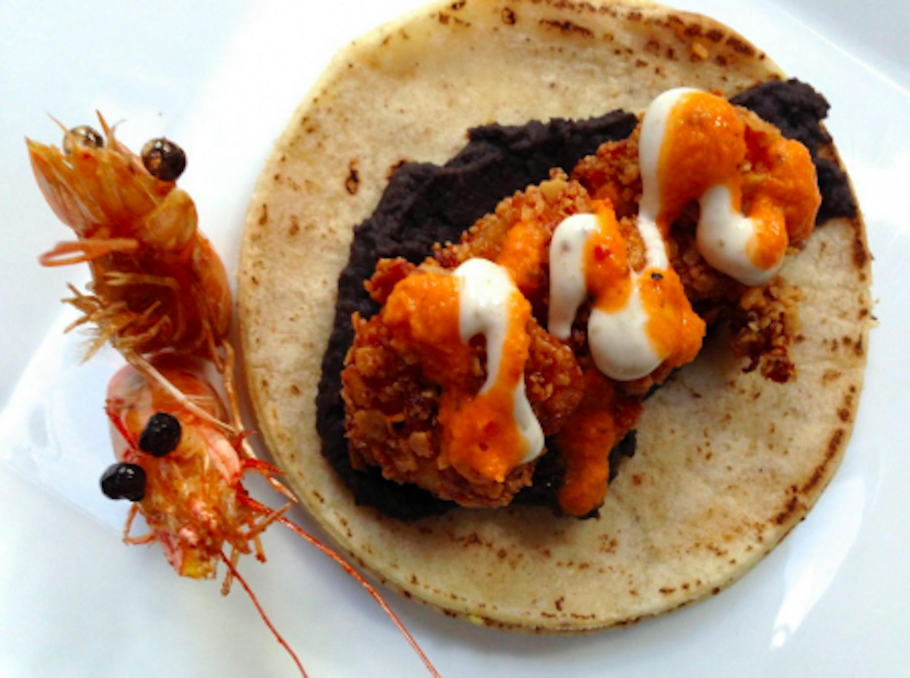 Boo! Refried black beans, tortilla-crusted shrimp, orange sauce, and beady eyes.