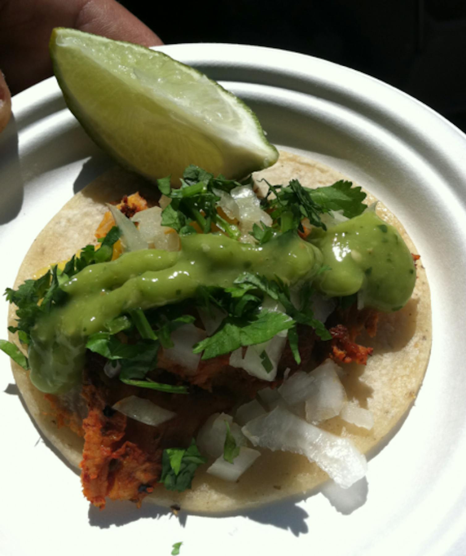 tacos al pastor served with onion and cilantro topping with guacamole and lemon