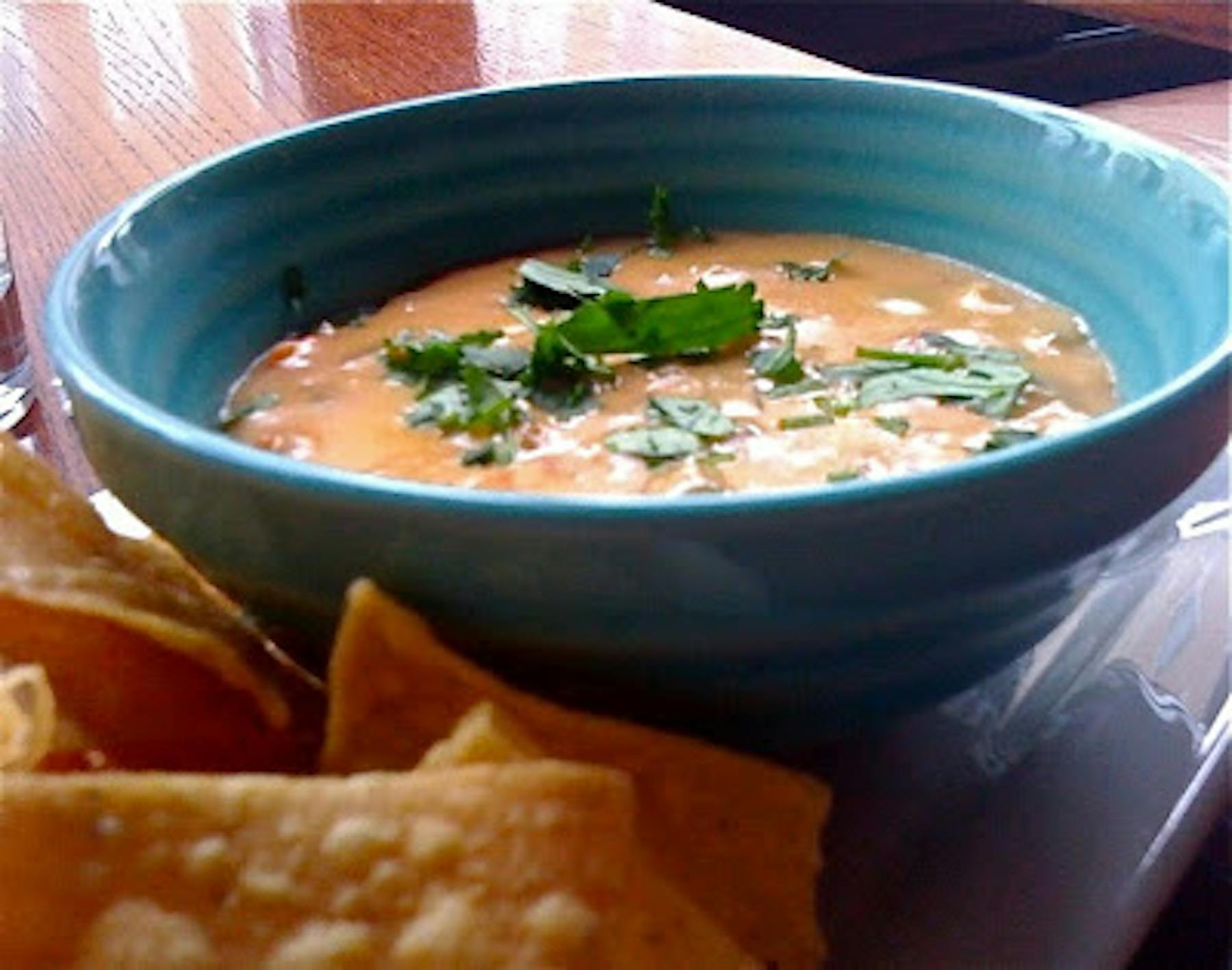 a plate of cheddar sauce and chips