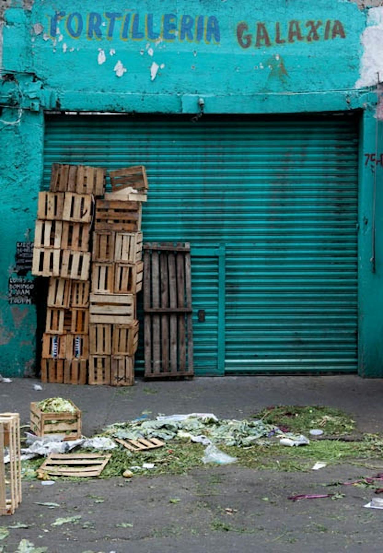 a vegetable market alley with empty boxes
