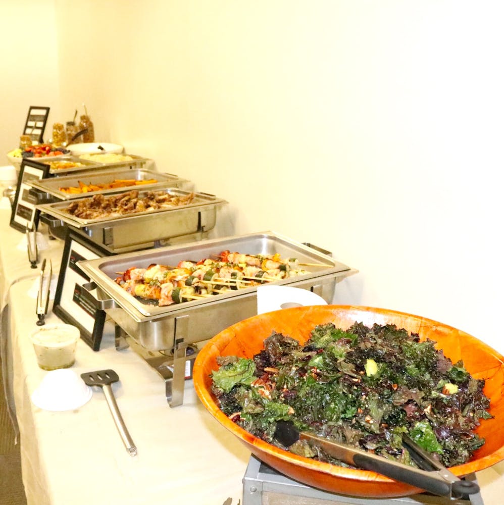 a buffet of salat, skewers, and other food