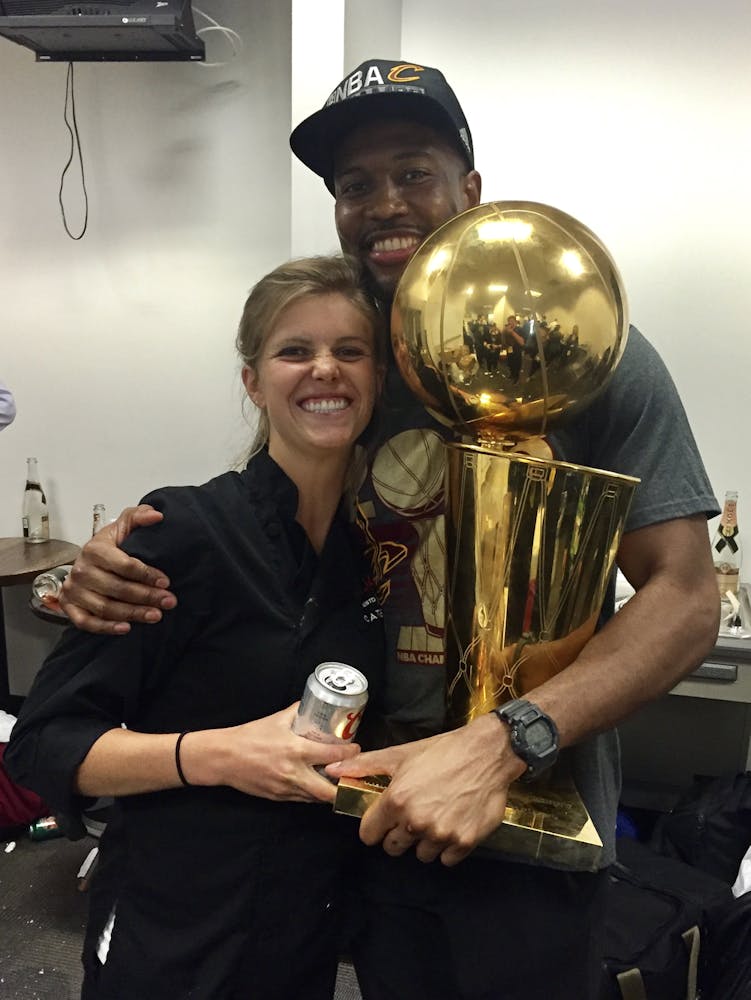 Chef Anja next to a basketball player holding a trophy