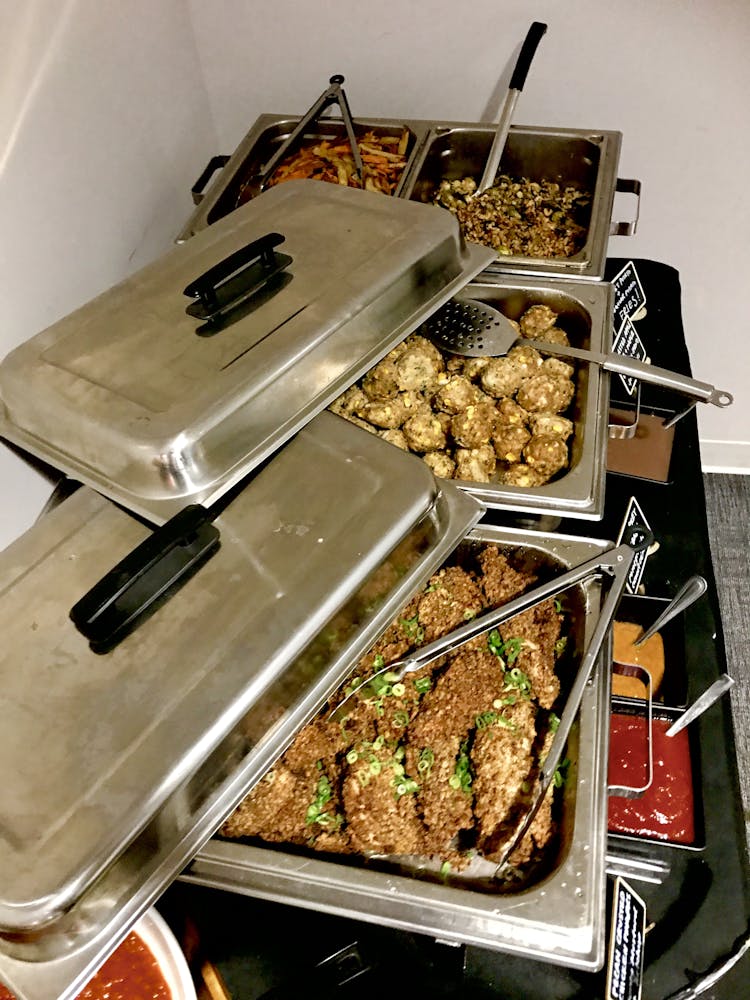 a buffet of food in silver trays
