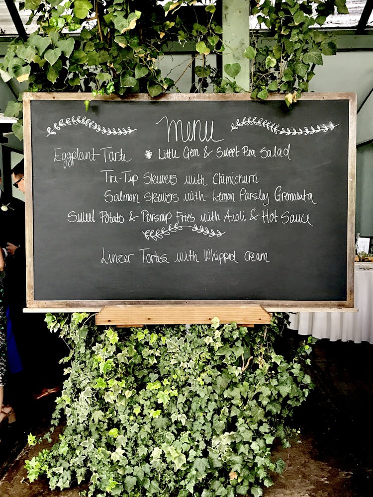 chalkboard with a menu written on it surrounded by vines