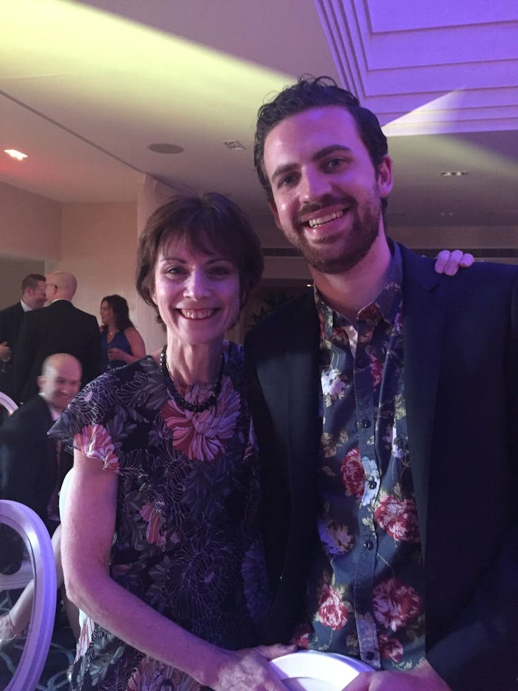 a man and a woman standing in front of a stage