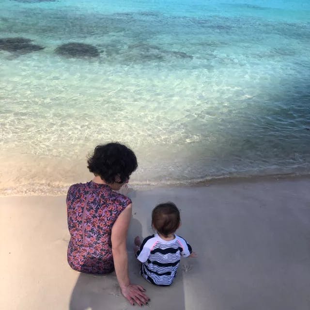 a little boy that is standing in the water